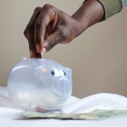 placing money in piggy bank